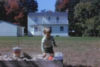 August, 1963. Jeanne Marie Brink and sandbox at Irwin Jay Brink Residence - 721 Lugers road, Holland, Michgan.